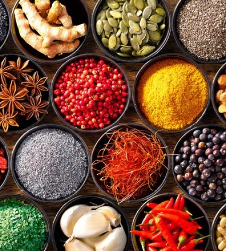 Colourful background from various herbs and spices for cooking in bowls. Top view